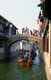 China: Boats and bridge on a canal in the ‘Water Town’ of Zhouzhuang, Jiangsu Province