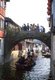 China: Boats and bridge on a canal in the ‘Water Town’ of Zhouzhuang, Jiangsu Province